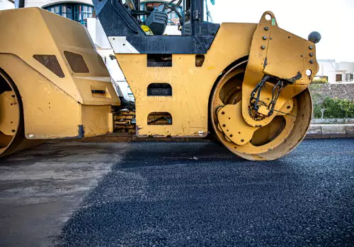 A roller on a roadway, part of the process of commercial asphalt paving in Illinois